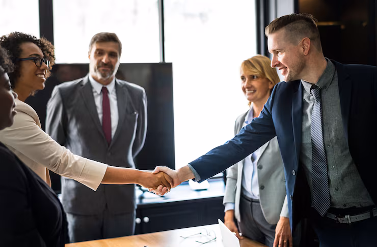 Partners shaking hands in a meeting — collaboration and mutual commitment.